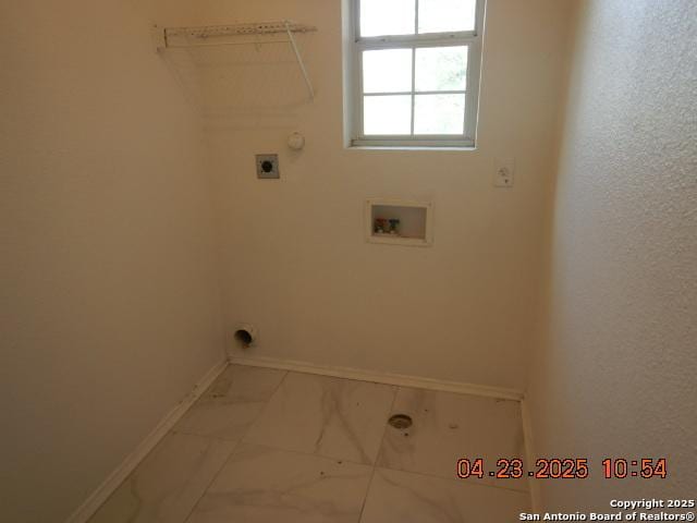 laundry area featuring baseboards, marble finish floor, laundry area, and electric dryer hookup