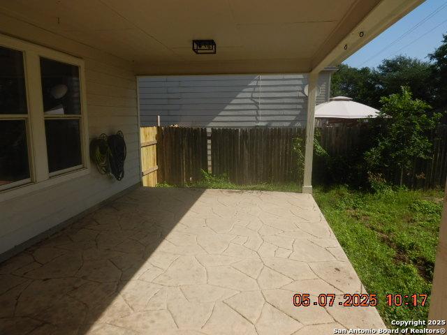 9922 Dull Knife Way, San Antonio, TX 78239 - view of patio / terrace with fence and a carport