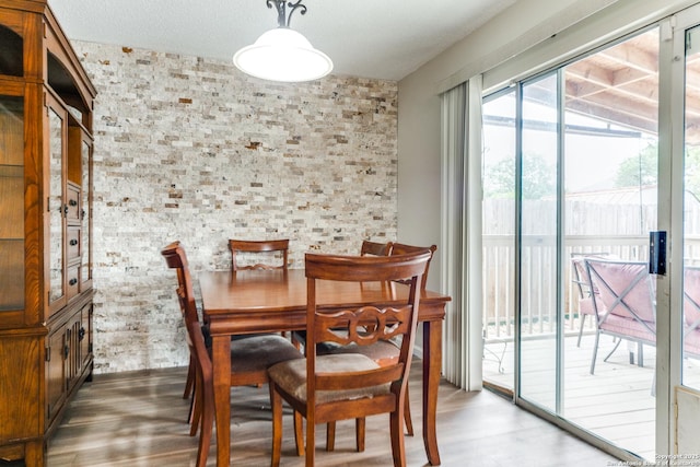 dining space with wood finished floors