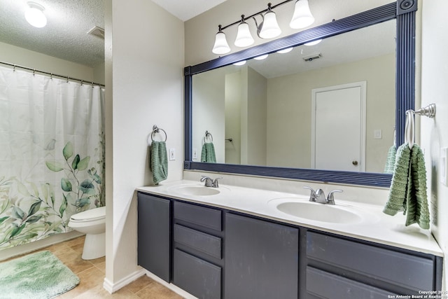 full bath featuring double vanity, visible vents, tile patterned flooring, and a sink