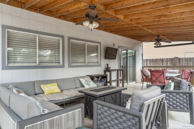 wooden deck with an outdoor hangout area, fence, and a ceiling fan