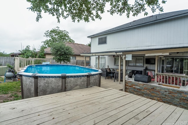 view of pool featuring a deck, a fenced in pool, and fence