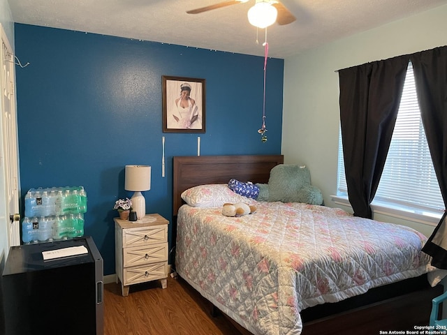 bedroom with ceiling fan and wood finished floors