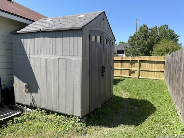 view of shed with fence