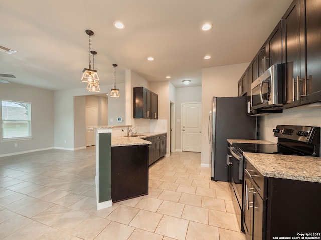 120 Lakeview Ct, Spring Branch, TX 78070 - kitchen with light stone countertops, baseboards, visible vents, a peninsula, and stainless steel appliances