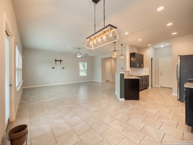 120 Lakeview Ct, Spring Branch, TX 78070 - kitchen with a ceiling fan, freestanding refrigerator, open floor plan, light tile patterned flooring, and recessed lighting