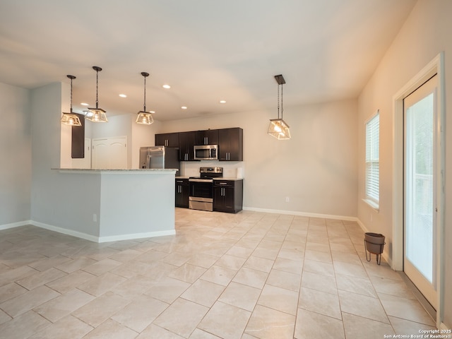 120 Lakeview Ct, Spring Branch, TX 78070 - kitchen featuring recessed lighting, baseboards, hanging light fixtures, a peninsula, and appliances with stainless steel finishes