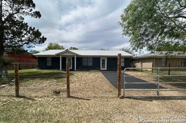 1107 Willow, Jourdanton, TX 78026 - ranch-style home featuring a gate, fence private yard, and metal roof