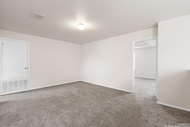 carpeted spare room with baseboards and visible vents