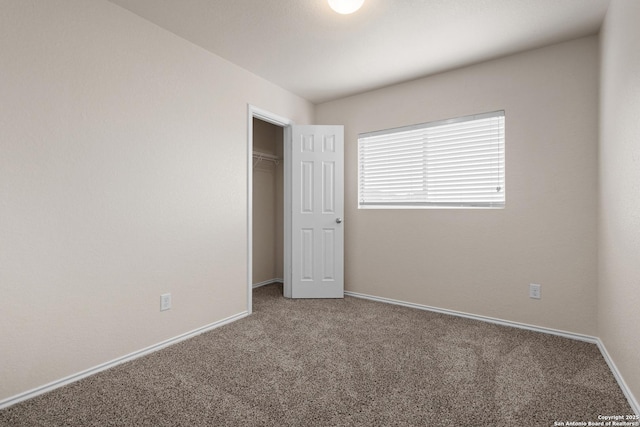 unfurnished bedroom with carpet, baseboards, and a closet