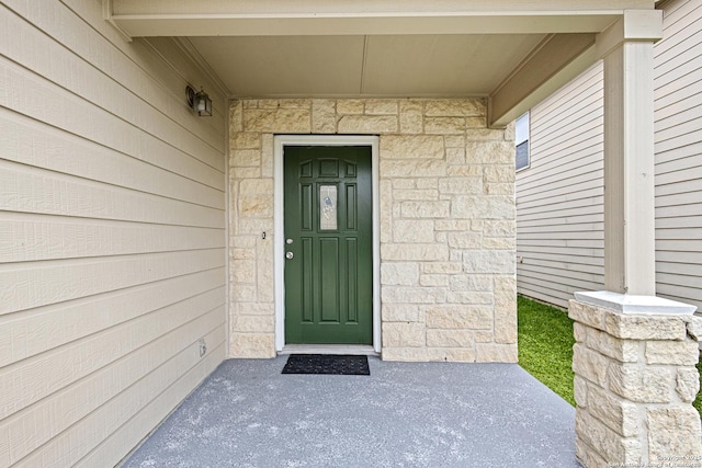 property entrance with stone siding