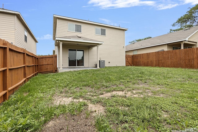 back of house featuring a lawn, a patio, and a fenced backyard