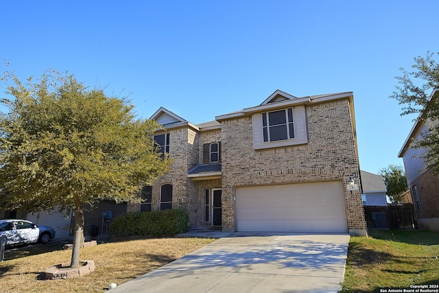 242 Posey Pass, New Braunfels, TX 78132 - traditional-style home with fence, an attached garage, brick siding, and driveway