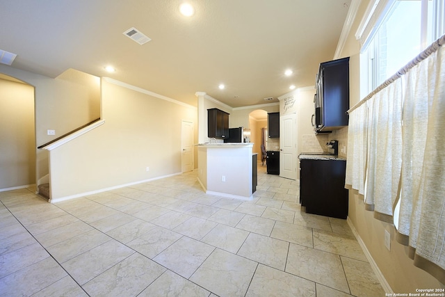 242 Posey Pass, New Braunfels, TX 78132 - kitchen with recessed lighting, ornamental molding, visible vents, stainless steel fridge, and arched walkways