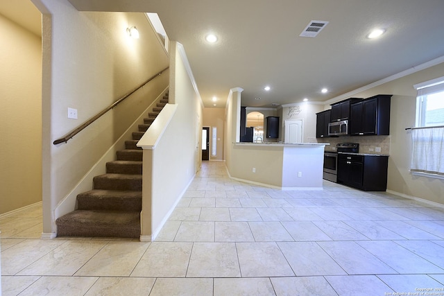 242 Posey Pass, New Braunfels, TX 78132 - kitchen with recessed lighting, dark cabinets, visible vents, backsplash, and stainless steel appliances