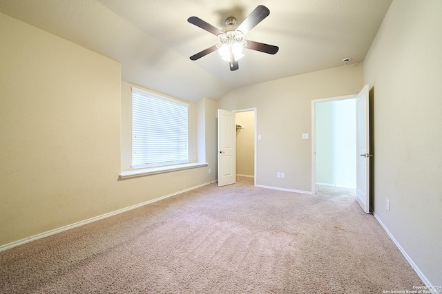 242 Posey Pass, New Braunfels, TX 78132 - unfurnished bedroom featuring lofted ceiling, light colored carpet, a ceiling fan, a walk in closet, and baseboards