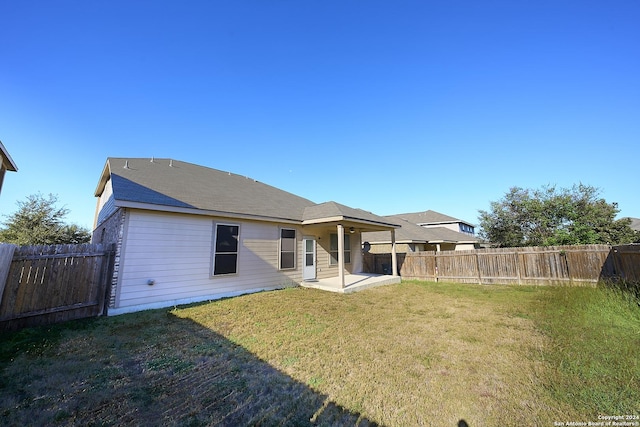 242 Posey Pass, New Braunfels, TX 78132 - rear view of property featuring a lawn, a patio area, and a fenced backyard