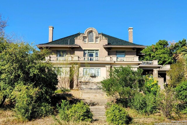 602 W French Pl, San Antonio, TX 78212 - back of property with a balcony, stairs, and a chimney