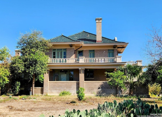 602 W French Pl, San Antonio, TX 78212 - back of house featuring brick siding, a chimney, and a balcony