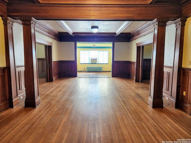 602 W French Pl, San Antonio, TX 78212 - empty room with wainscoting, decorative columns, and radiator heating unit