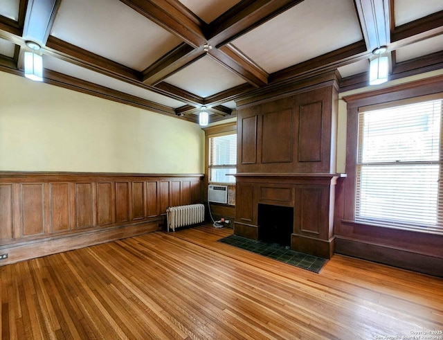 602 W French Pl, San Antonio, TX 78212 - unfurnished living room with light wood-style flooring, coffered ceiling, radiator heating unit, beam ceiling, and a large fireplace