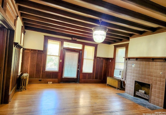 602 W French Pl, San Antonio, TX 78212 - unfurnished living room with radiator, wainscoting, beam ceiling, and wood finished floors