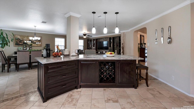 6139 Mackenzie, San Antonio, TX 78247 - kitchen featuring dark brown cabinets, crown molding, a ceiling fan, arched walkways, and a chandelier