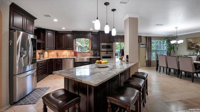 6139 Mackenzie, San Antonio, TX 78247 - kitchen with appliances with stainless steel finishes, a sink, dark brown cabinets, tasteful backsplash, and light tile patterned flooring