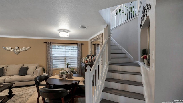 6139 Mackenzie, San Antonio, TX 78247 - staircase featuring crown molding, a textured ceiling, and wood finished floors
