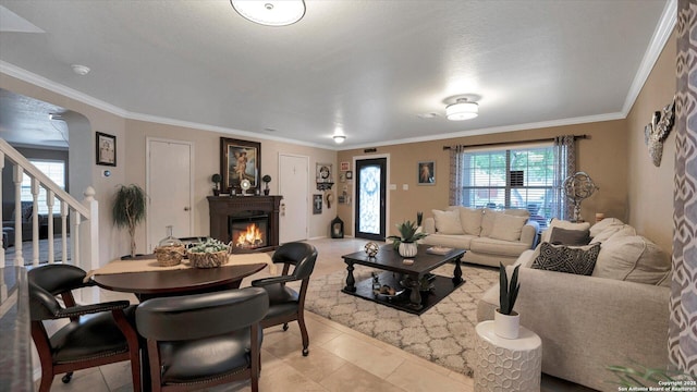 6139 Mackenzie, San Antonio, TX 78247 - living area featuring a glass covered fireplace, stairs, light tile patterned floors, and ornamental molding