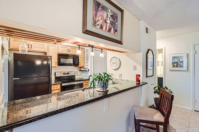 14343 Judson Unit 303, San Antonio, TX 78233 - kitchen with dark stone countertops, a textured ceiling, visible vents, black appliances, and light tile patterned flooring