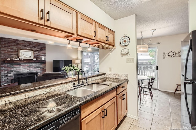 14343 Judson Unit 303, San Antonio, TX 78233 - kitchen featuring a sink, dark stone counters, freestanding refrigerator, a textured ceiling, and light tile patterned floors