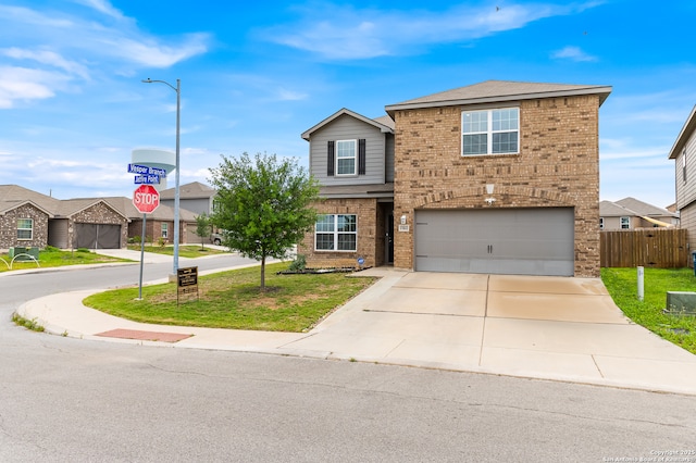 15102 Jetfire, Von Ormy, TX 78073 - traditional-style home featuring concrete driveway, a front yard, brick siding, and a garage