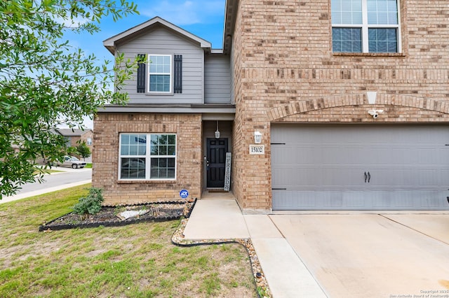 15102 Jetfire, Von Ormy, TX 78073 - traditional-style house featuring brick siding, driveway, and a garage