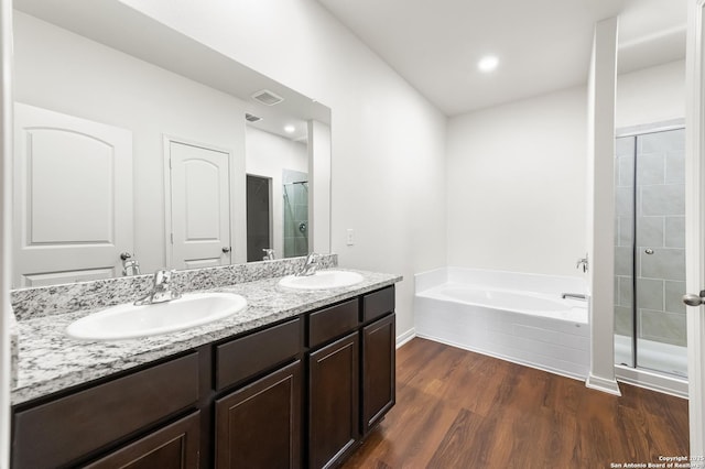 15102 Jetfire, Von Ormy, TX 78073 - full bathroom with a sink, a stall shower, a bath, and wood finished floors