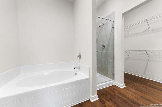 15102 Jetfire, Von Ormy, TX 78073 - full bathroom with a walk in closet, a shower stall, and wood finished floors