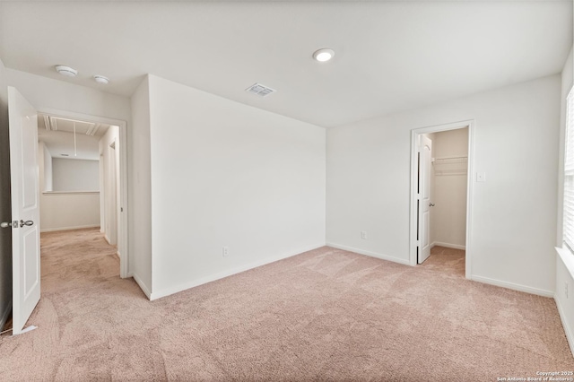 15102 Jetfire, Von Ormy, TX 78073 - unfurnished bedroom featuring attic access, baseboards, visible vents, a walk in closet, and light carpet
