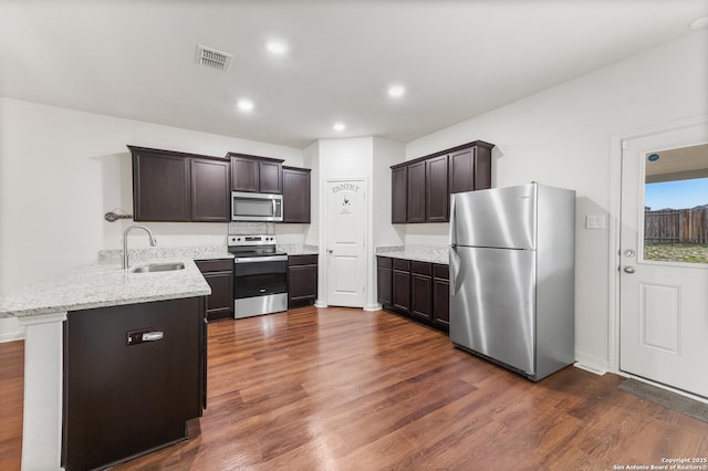 15102 Jetfire, Von Ormy, TX 78073 - kitchen featuring a peninsula, a sink, visible vents, appliances with stainless steel finishes, and dark wood-style floors