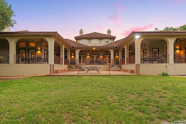 26118 Alto Oaks, San Antonio, TX 78255 - rear view of property with a lawn, a patio area, stucco siding, and a tile roof