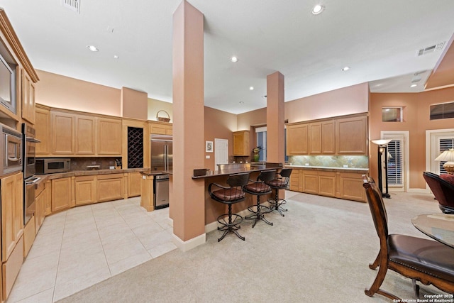 26118 Alto Oaks, San Antonio, TX 78255 - kitchen with built in appliances, a kitchen breakfast bar, tasteful backsplash, light carpet, and recessed lighting