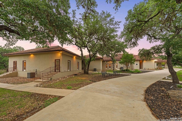 26118 Alto Oaks, San Antonio, TX 78255 - view of front of house with central air condition unit, stucco siding, and a tile roof