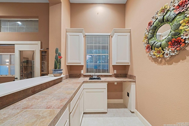 26118 Alto Oaks, San Antonio, TX 78255 - kitchen with white cabinetry, light tile patterned flooring, a sink, and baseboards