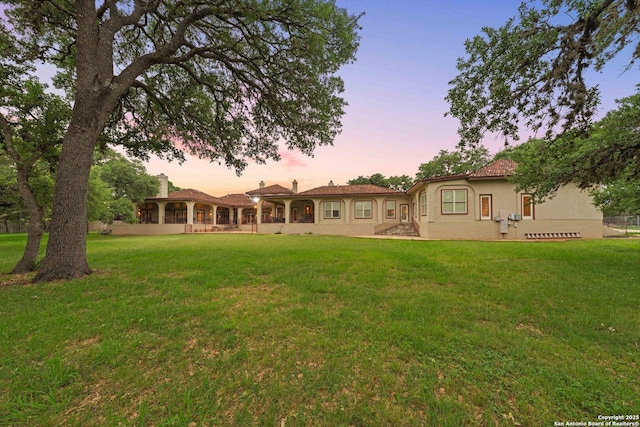 26118 Alto Oaks, San Antonio, TX 78255 - rear view of house featuring stucco siding and a lawn