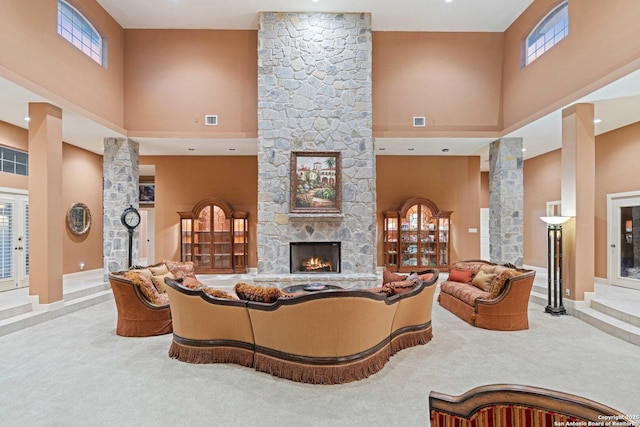 26118 Alto Oaks, San Antonio, TX 78255 - living room featuring carpet flooring, a towering ceiling, decorative columns, a fireplace, and healthy amount of natural light