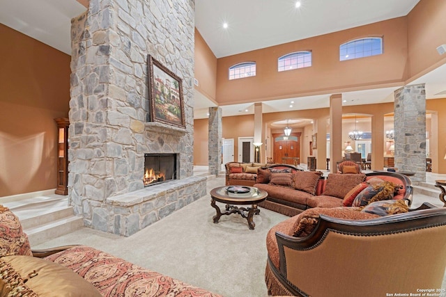 26118 Alto Oaks, San Antonio, TX 78255 - living area with ornate columns, a high ceiling, a stone fireplace, and carpet floors