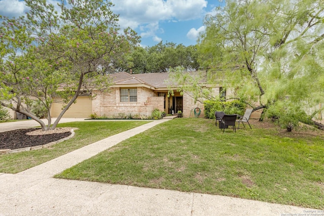 ranch-style house featuring driveway, brick siding, and a front lawn