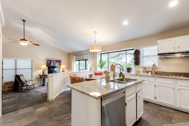 kitchen featuring stone tile floors, under cabinet range hood, stainless steel dishwasher, a sink, and gas cooktop