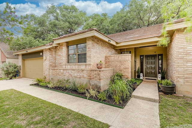 view of front of property featuring concrete driveway, brick siding, and an attached garage