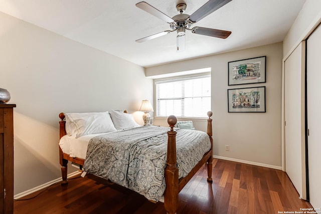 bedroom featuring baseboards, a closet, a ceiling fan, and wood finished floors