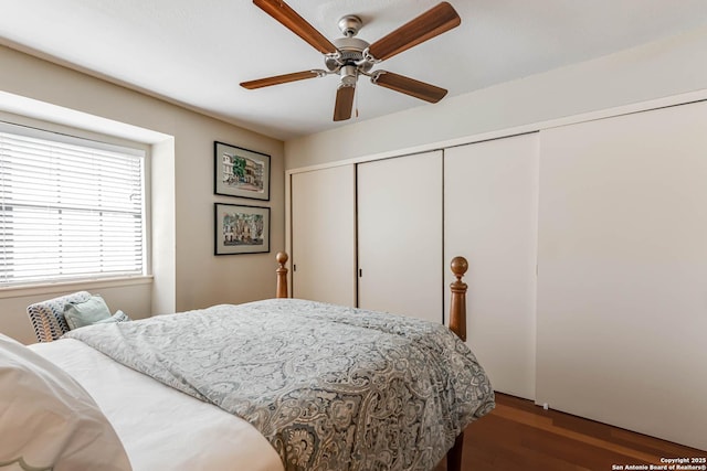 bedroom with a closet, a ceiling fan, and wood finished floors